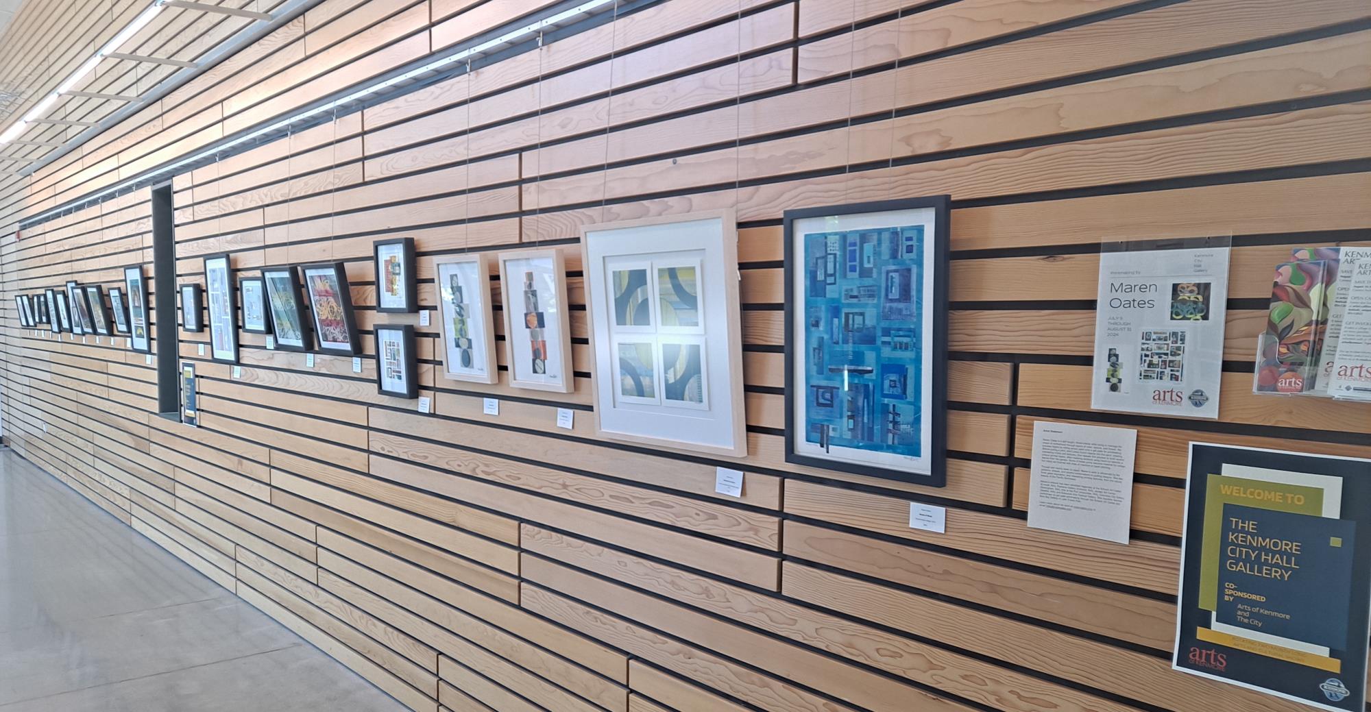 Art gallery wall at City Hall featuring a myriad of abstract paintings.