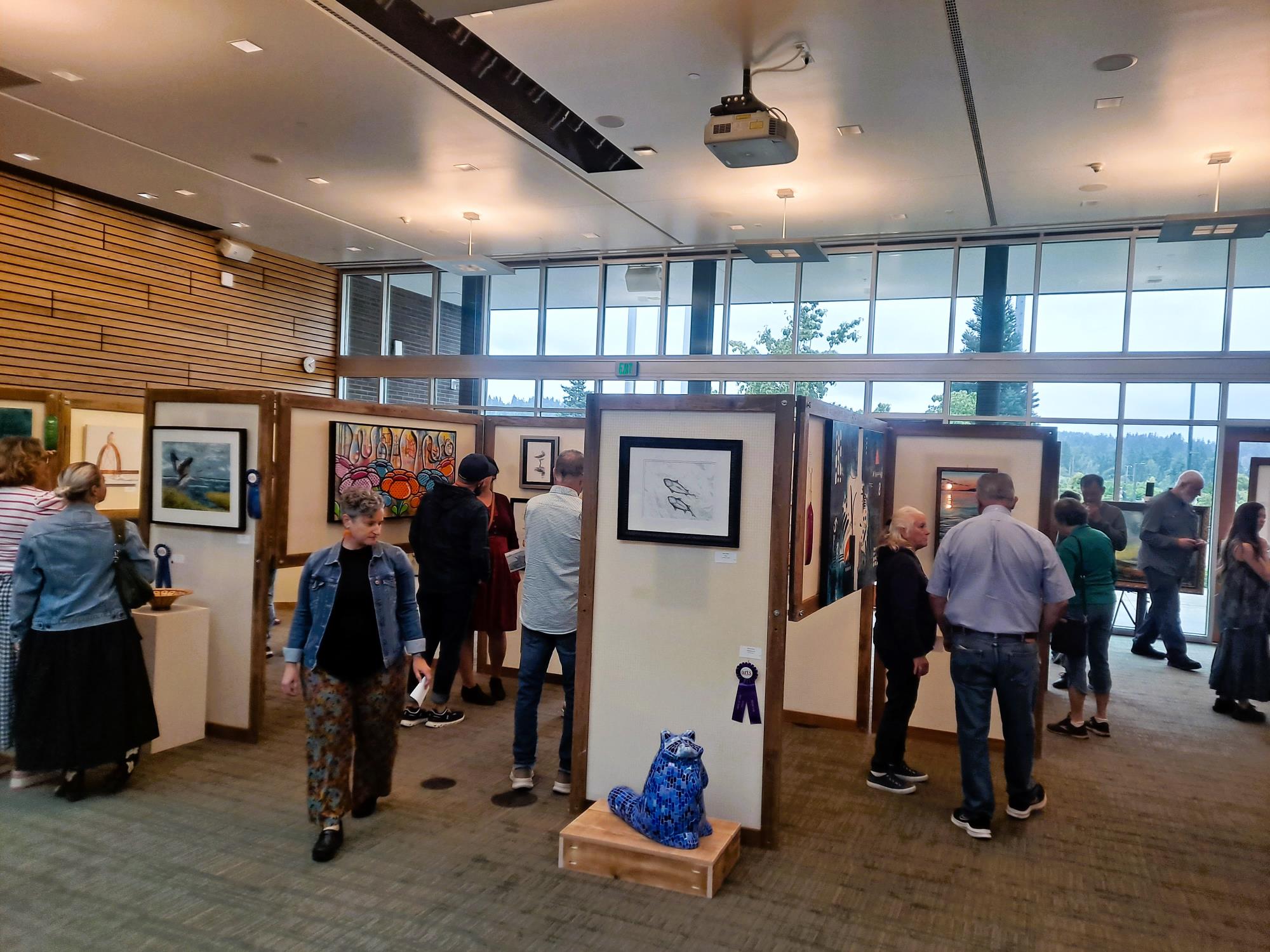 As part of the Kenmore Art Show, members of the community view art in Kenmore's council chambers.