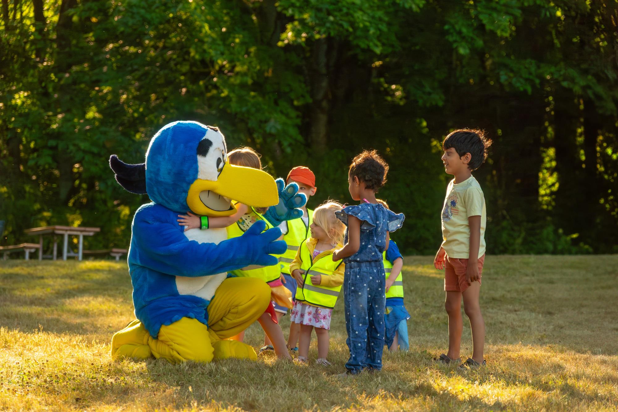 Hank Heron gives out hugs to a group of children at one of Kenmore's summer concerts.